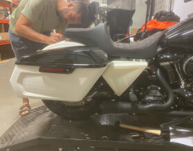 A man fixing a bike in a garage