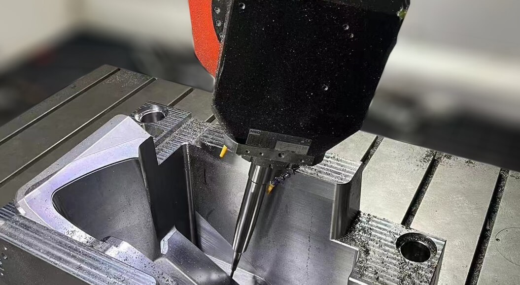 A machine cutting metal on a table